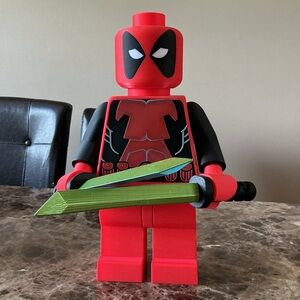 Red and Black, 16” Dead Pool Action Figure with tri colored Swords